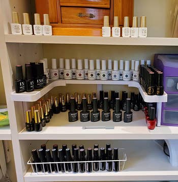 a reviewer photo of nail polish on a bathroom shelve organized with the expandable rack 