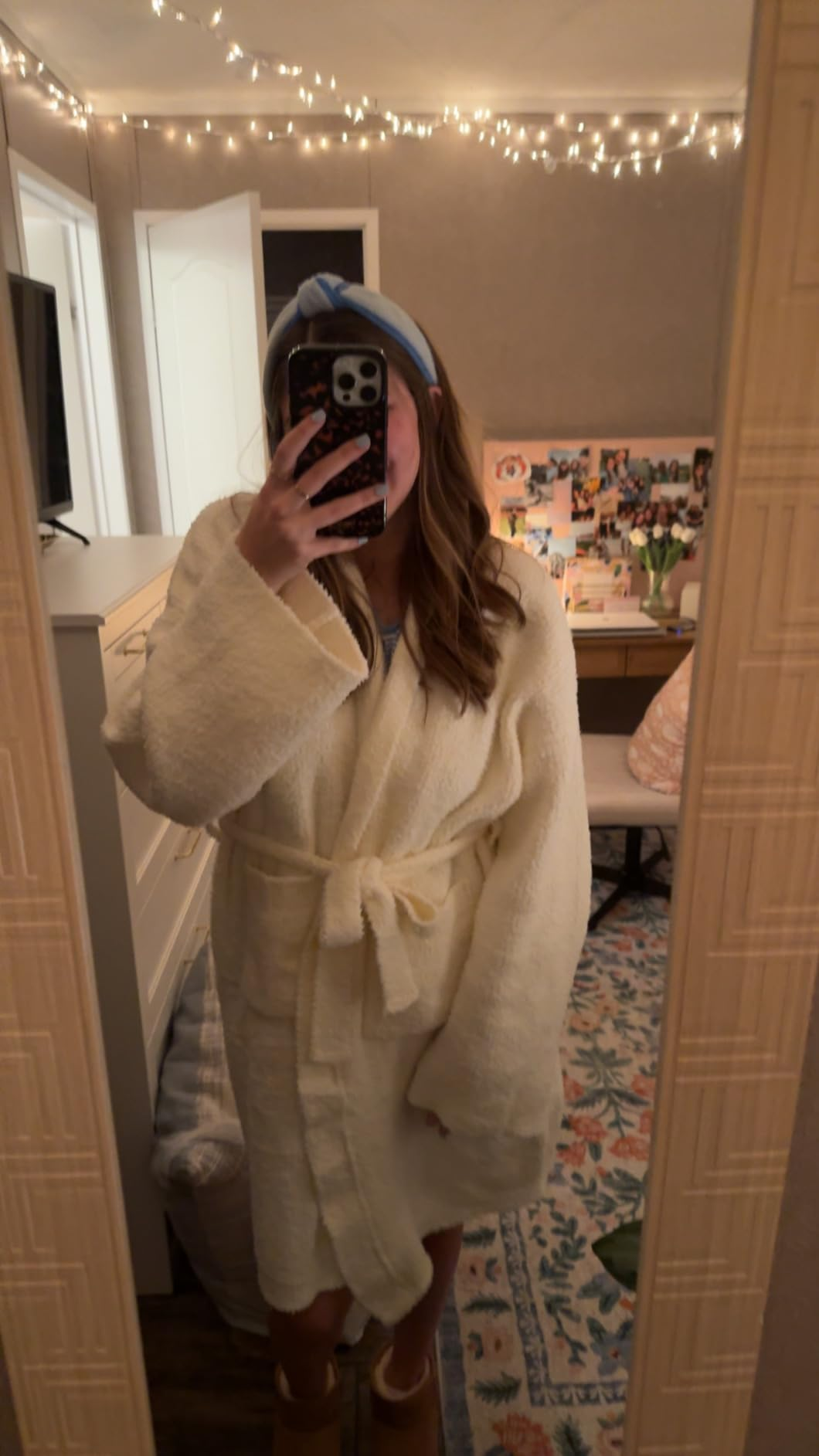 Person taking a reflector  selfie wearing a cozy robe and a headband successful  a decorated room; nonfiction  is astir  shopping