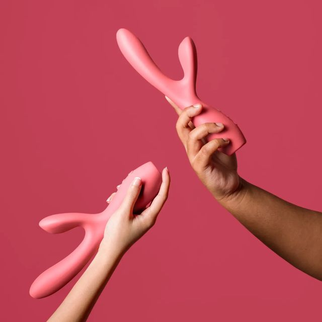Hands holding red rabbit vibrators