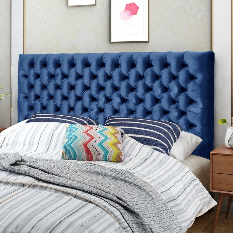 the upholstered headboard in blue