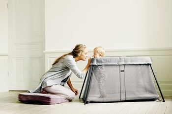 A baby in the travel crib