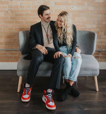 couple with person in suit and sneakers wearing the bolo tie over a shirt 