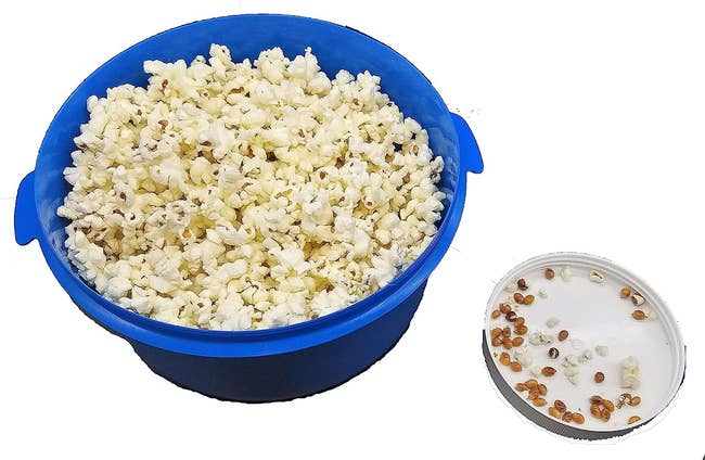The blue bowl with removed tray filled with unpopped kernels