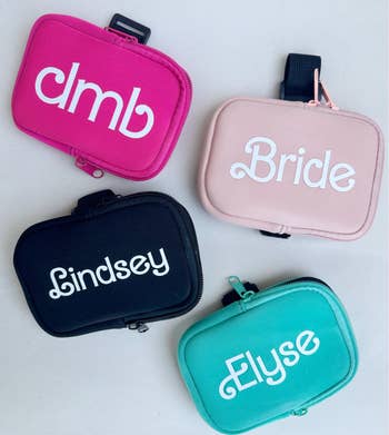 four pouches with writing on them in a barbie font