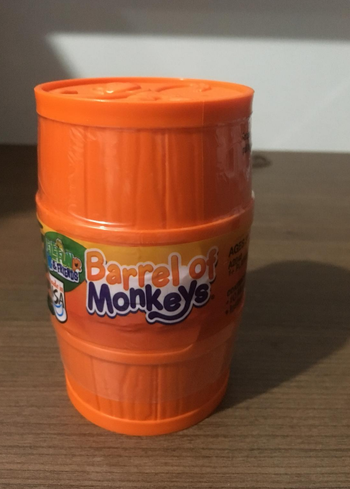 Reviewer image of plastic orange barrel-shaped container that reads 