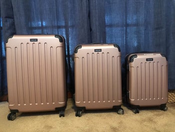 reviewer photo of three-piece rose gold suitcase set