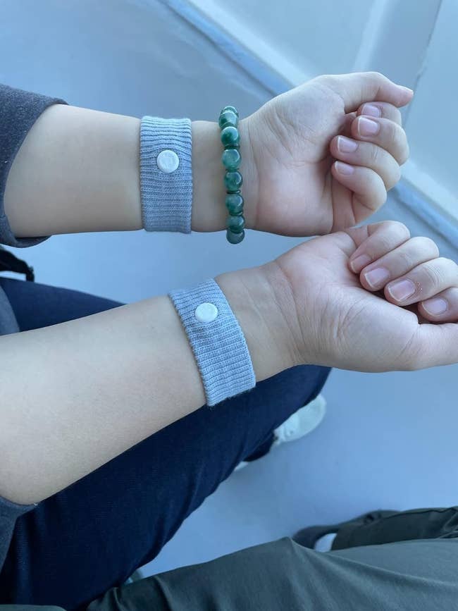 Close-up of 2 wrists wearing anti-nausea wristbands