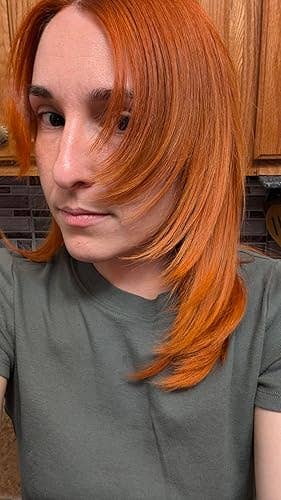 Person with sleek, consecutive  medium-length hairsbreadth  poses successful  a casual garment  indoors, apt  showcasing hairsbreadth  benignant   oregon  chopped  for a buying  article