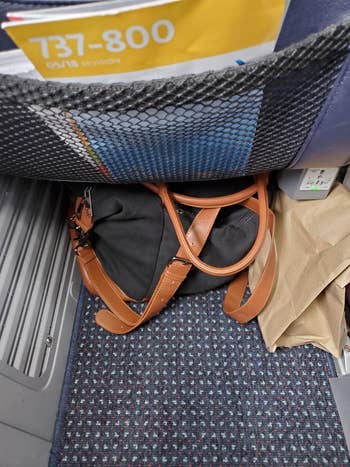 another reviewers black bag under the airplane seat