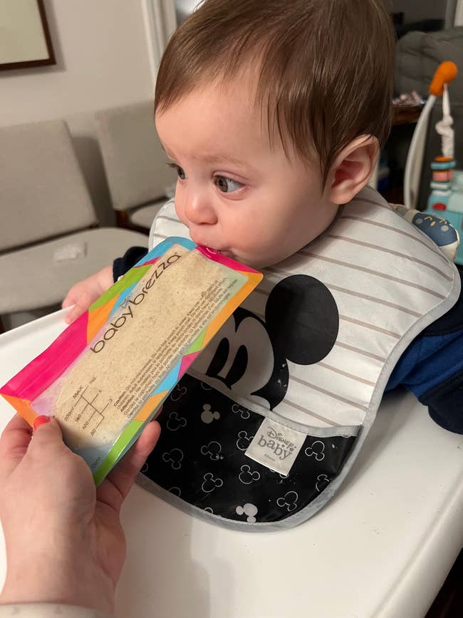 editor's baby eating out of a reusable baby brezza pouch