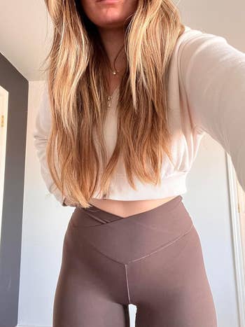 close up of another reviewer in the brown leggings showing waist crossover detail