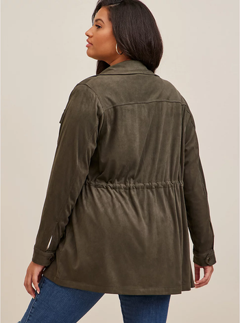 back of a model wearing an olive shacket and blue jeans