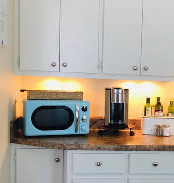 reviewer photo of the blue microwave on a kitchen counter