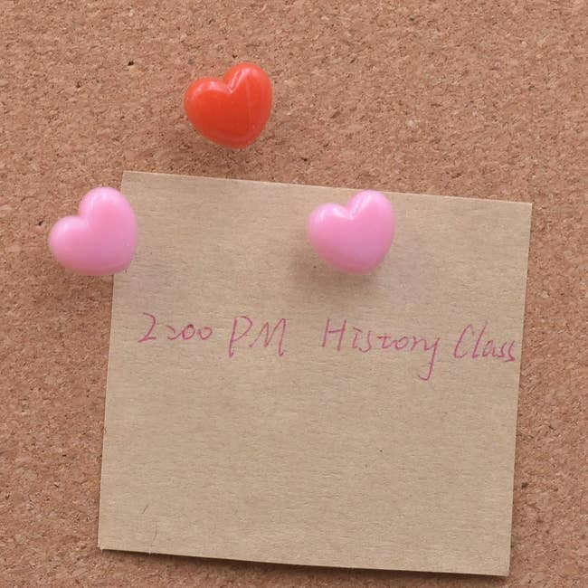 Sticky note with heart-shaped pins 