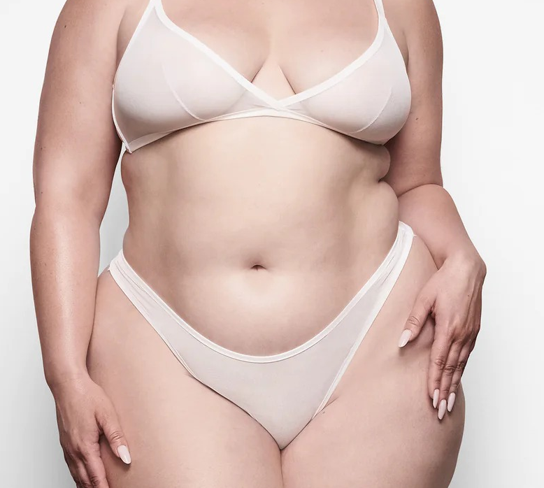 model wearing the triangle bralette in white