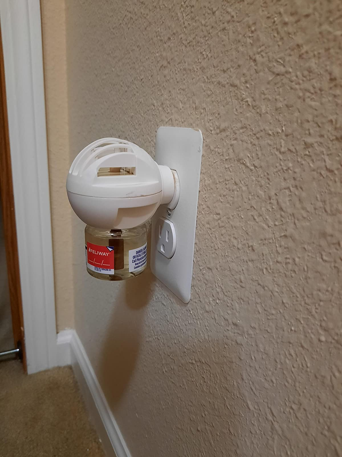 the feliway diffuser plugged into a reviewer's wall