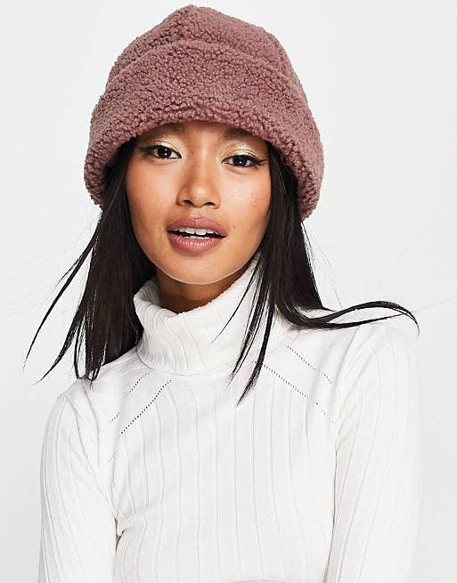 a model posing in the mauve colored beanie