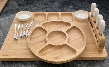 reviewer photo of empty charcuterie board, complete with knives and bowls