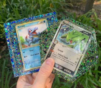 seller holding Totodile and Tyranitar coasters