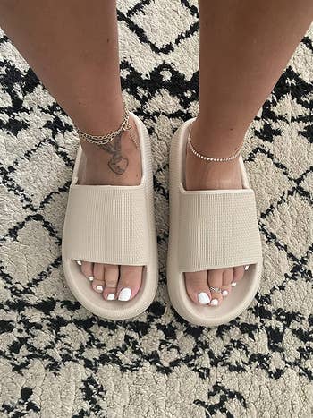 a reviewer wearing the beige sandals