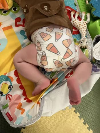 a baby wearing a candy corn printed diaper