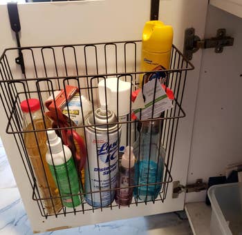 reviewer photo of the basket being used to hold cleaning products