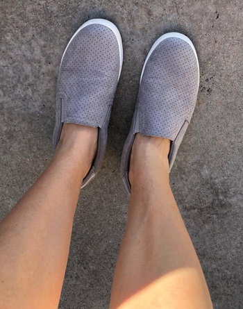 reviewer wearing the gray slip-ons