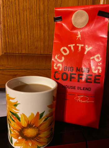 a reviewer photo of a a bag of scotty p's coffee and a mug filled with coffee