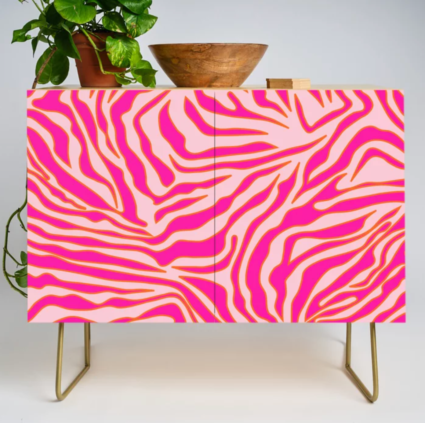 Pink and gold zebra printed bar cabinet with gold legs
