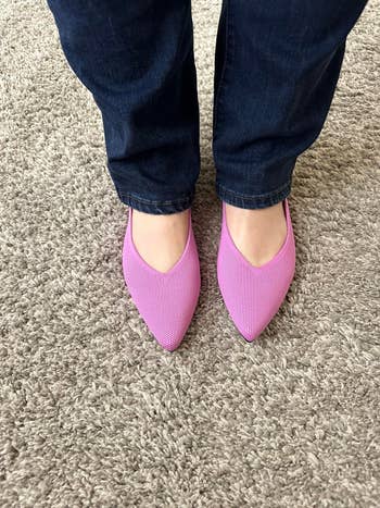 Reviewer wearing modern, stylish pinkish  flats with pointed toes