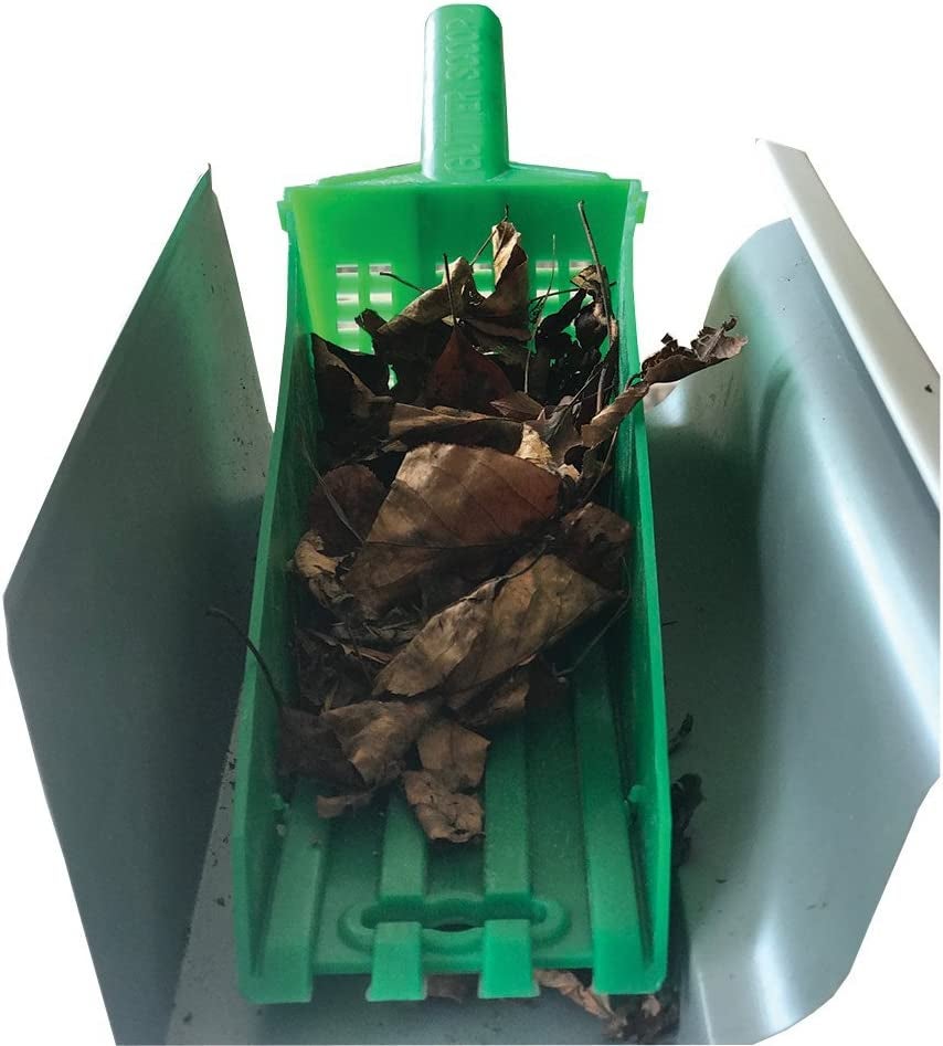 the gutter scoop in a gutter filled with leaves 
