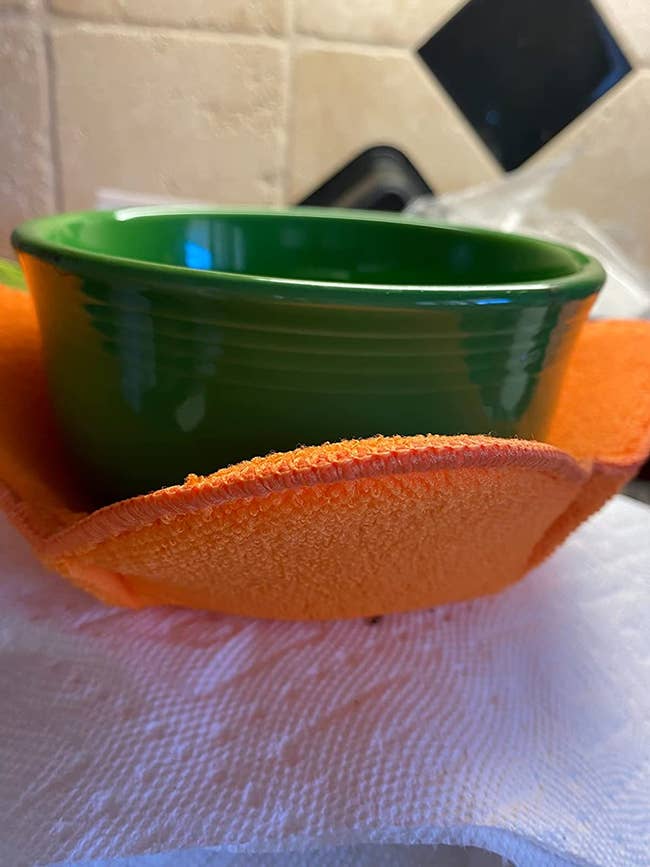 an orange bowl hugger around a green bowl