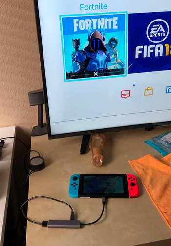 reviewer's setup with their switch plugged into a TV using the portable dock