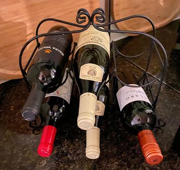 Reviewer image of black wine rack with bottles