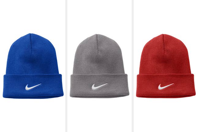Blue, gray, and red hats with Nike logo embroidered on the front on a white background