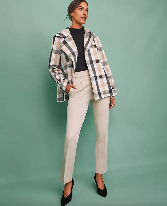 model in white tan and black plaid double breasted jacket