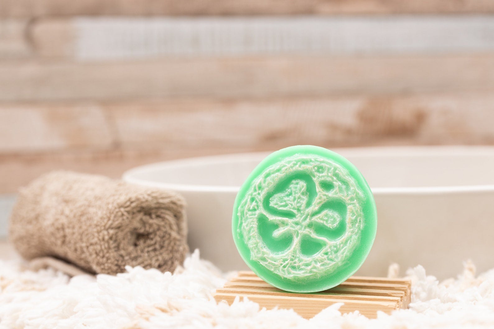 Green soap loofah placed on soap tray near sink
