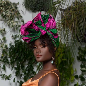 model waring a pink and green head wrap 