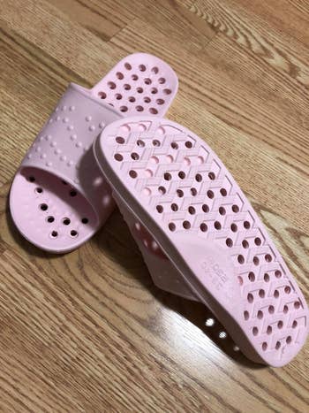 the pink shower sandals with holes in the soles