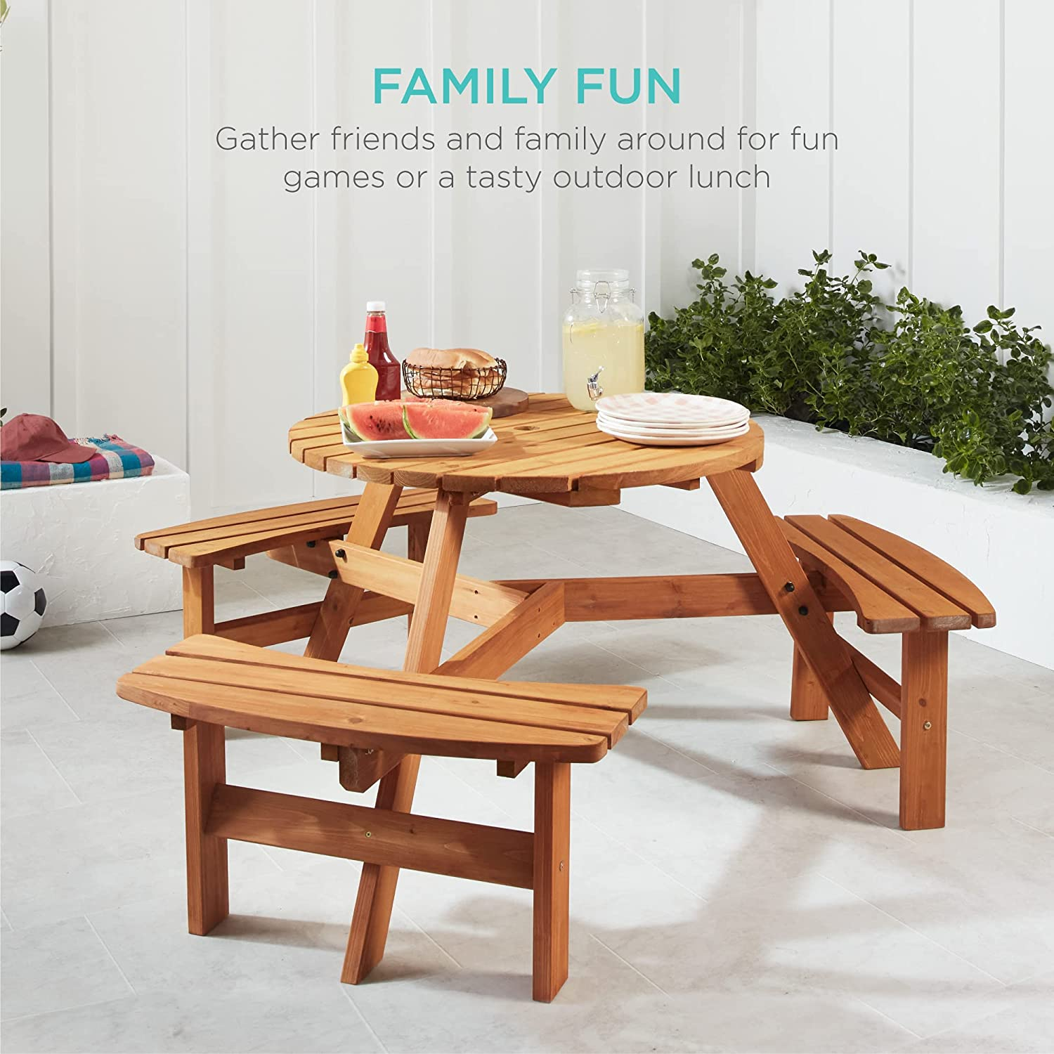 the wooden outdoor picnic table with three built-in benches