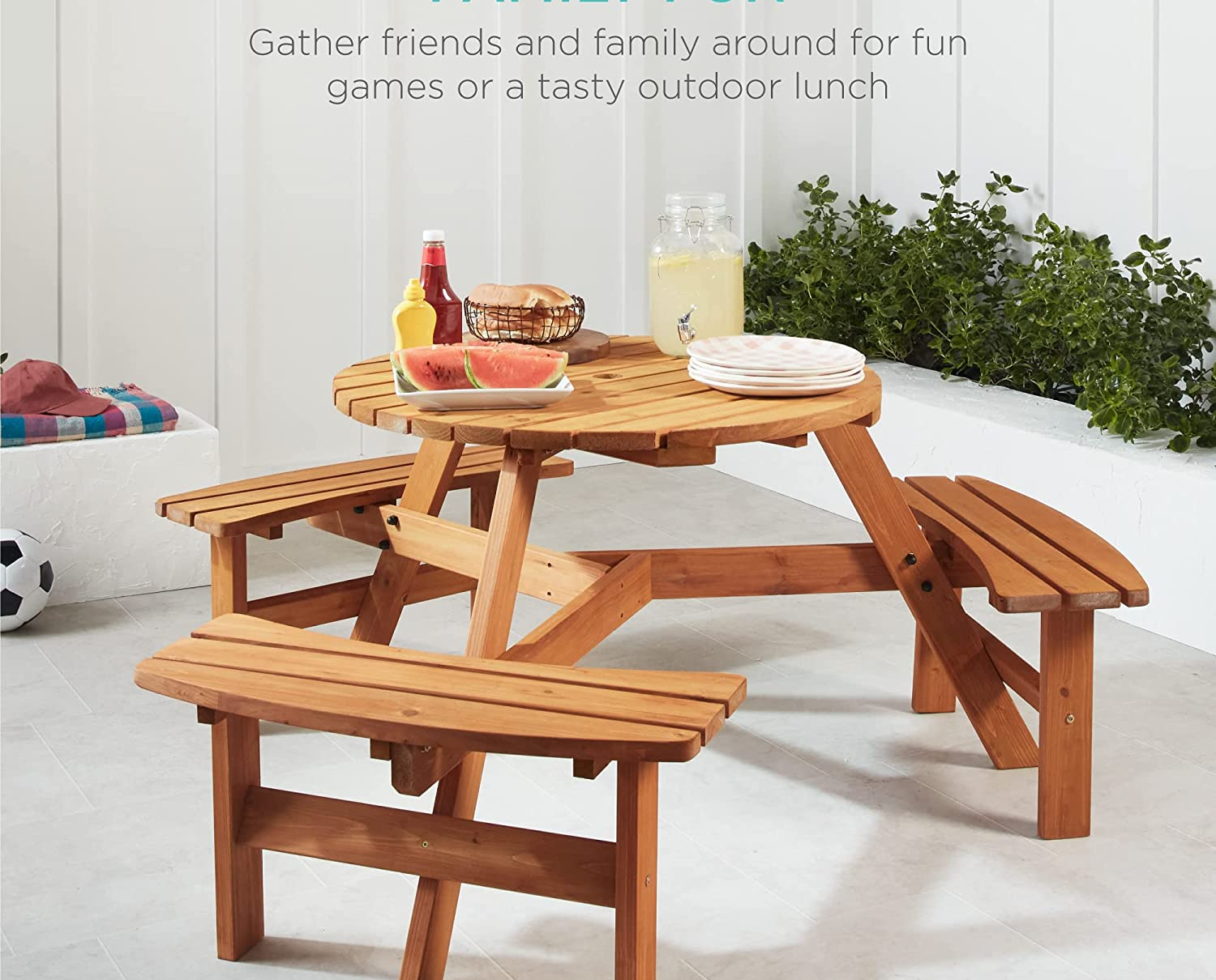the wooden outdoor picnic table with three built-in benches
