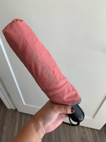 writer holding up her weatherman umbrella