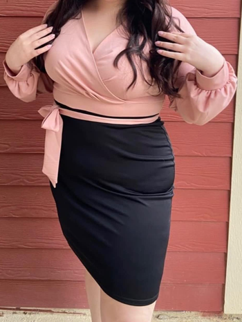 Image of reviewer wearing pink and black dress