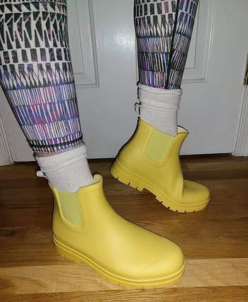 close up of the yellow boots on a reviewer's feet