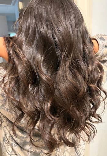 Long, wavy brownish hairsbreadth styled successful escaped curls cascading down the back