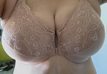 A lace-patterned bra worn by a person, highlighting intimate apparel featured successful  a buying  context