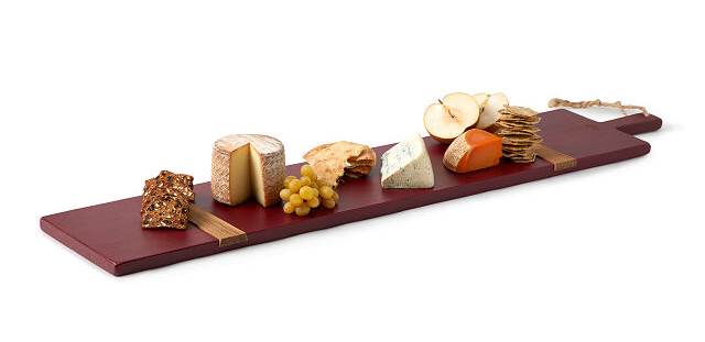 a cheese board with cheese, crackers, and fruits displayed