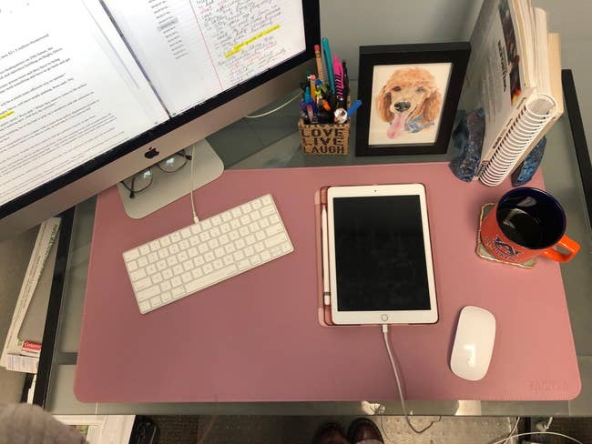the pink waterproof desk mat on a desk