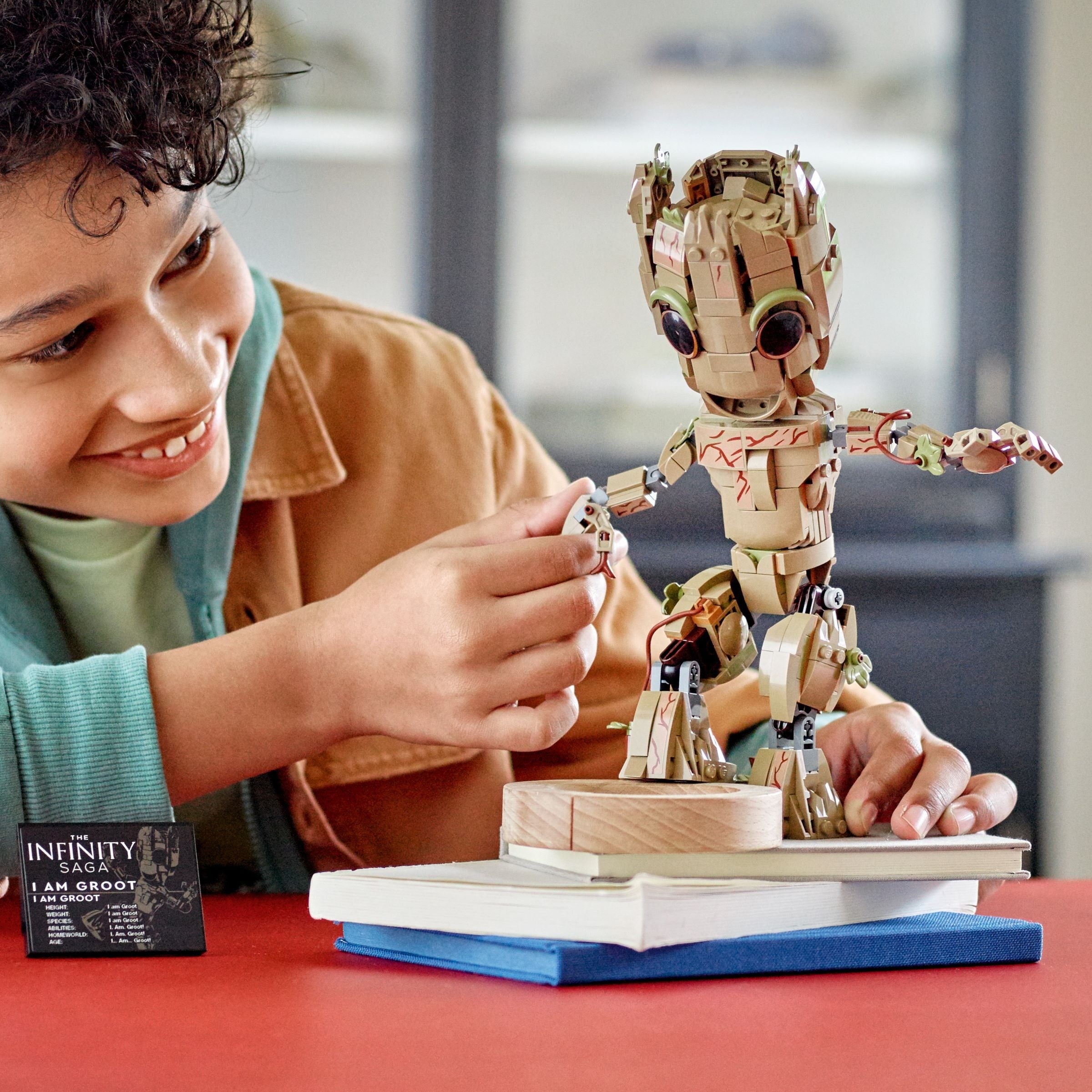child holding the Groot Lego figure