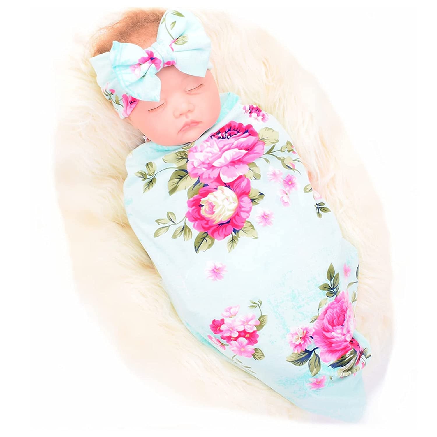 Model wrapped in blue and pink floral baby blanket with matching headband with bow